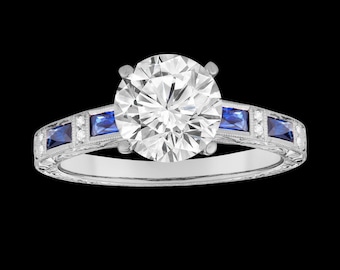 May include: A silver-toned ring featuring a large, round, clear faceted center stone. The band is accented with four rectangular, deep blue sapphire-colored stones and small, round, clear accent stones set in a detailed, engraved metal band.
