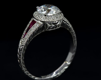 May include: A silver engagement ring with a large round diamond center stone and a halo of smaller diamonds. The band is decorated with a filigree design and has two red ruby accents.