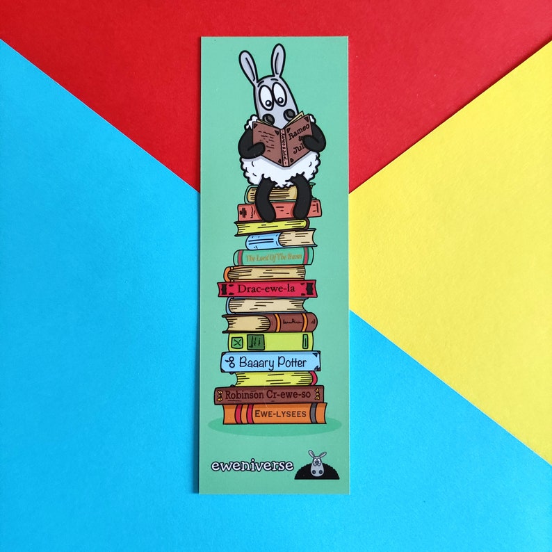 May include: A green bookmark featuring a cartoon sheep reading a book titled "Rameo and Juliet". The sheep is perched on a stack of books with titles such as "The Lord of The Ewe", "Drac-ewe-la", "8 Baaary Potter", "Robinson Cr-ewe-so", and "EWE-LYSEES". The bookmark also includes the text "eweniverse" at the bottom.