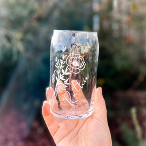 May include: A clear glass with a floral design and the name "Ruth" etched on the side.