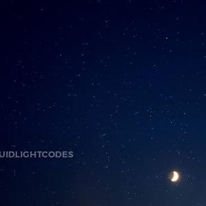 May include: A dark blue night sky with a crescent moon and many stars.