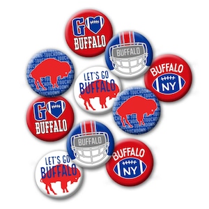 May include: Nine round buttons with various designs featuring the Buffalo Bills logo, including a football helmet, a buffalo silhouette, and the words "Go Buffalo" and "Let's Go Buffalo".