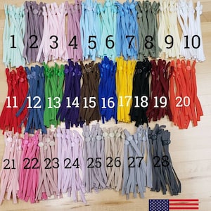 Pode incluir: Uma coleção de 28 cordões elásticos de 5 mm de diferentes cores com ajustadores de silicone. Os cordões estão dispostos em filas de 10, numeradas de 1 a 28.