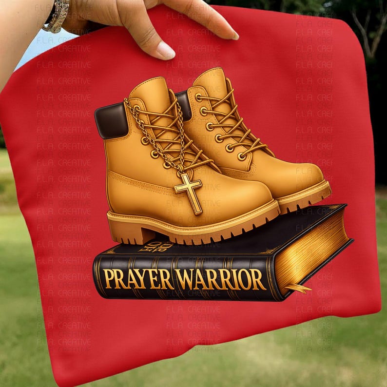 A pair of yellow boots with a cross on them, placed on top of a black book with the title "PRAYER WARRIOR" printed on it.
