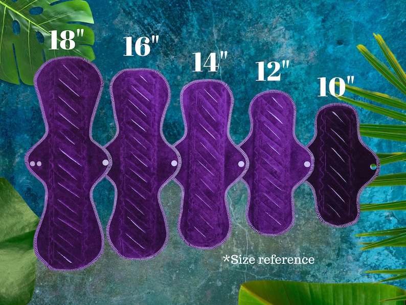 Five purple reusable cloth menstrual pads, sizes from 25.4 cm to 45.7 cm in length. Each pad has a quilted design and white stitching. The text "*Size reference" is at the bottom.