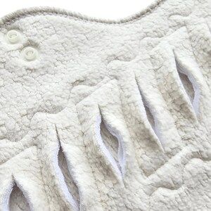 close up of a gusher pad slits on an organic cotton pad made with organic cotton sherpa