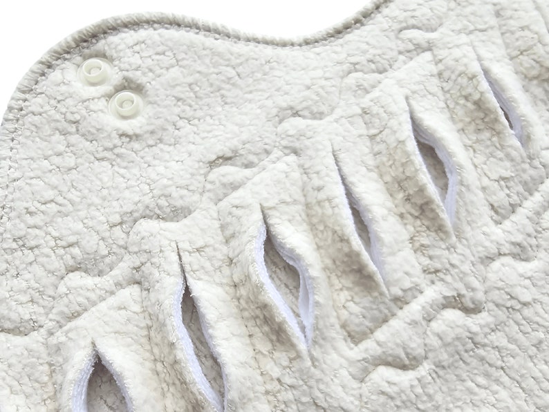 close up of a gusher pad slits on an organic cotton pad made with organic cotton sherpa