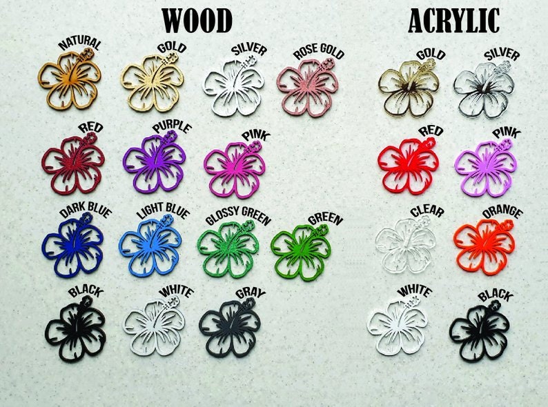 May include: A variety of wood and acrylic hibiscus flower cutouts in different colors, including natural, gold, silver, rose gold, red, purple, pink, dark blue, light blue, glossy green, green, clear, orange, black, white, and gray.
