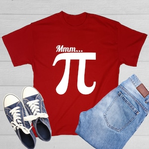 May include: Red t-shirt with a white graphic of the mathematical symbol pi and the text "Mmm..." above it.