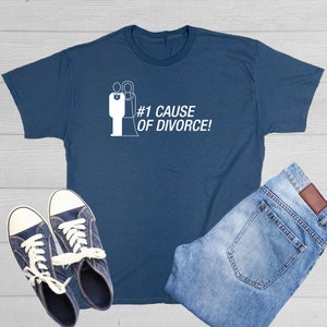 May include: A dark blue t-shirt with a white graphic of a wedding couple and the text '#1 CAUSE OF DIVORCE!'