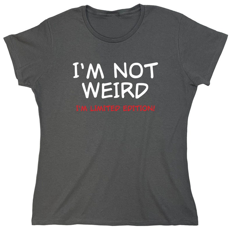 May include: A dark gray t-shirt with white text that reads "I'm not weird I'm limited edition!"