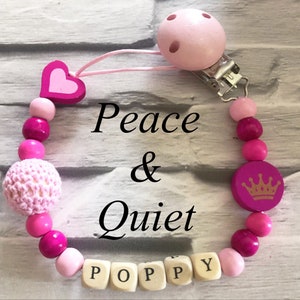 Beautiful handmade Personalised dummy clip, wooden dummy chain, wooden pacifier clip for a girl in bright and dark pink colours.