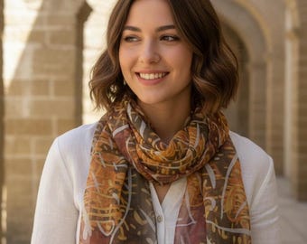 Hand-painted batik silk scarf in brown and yellow.