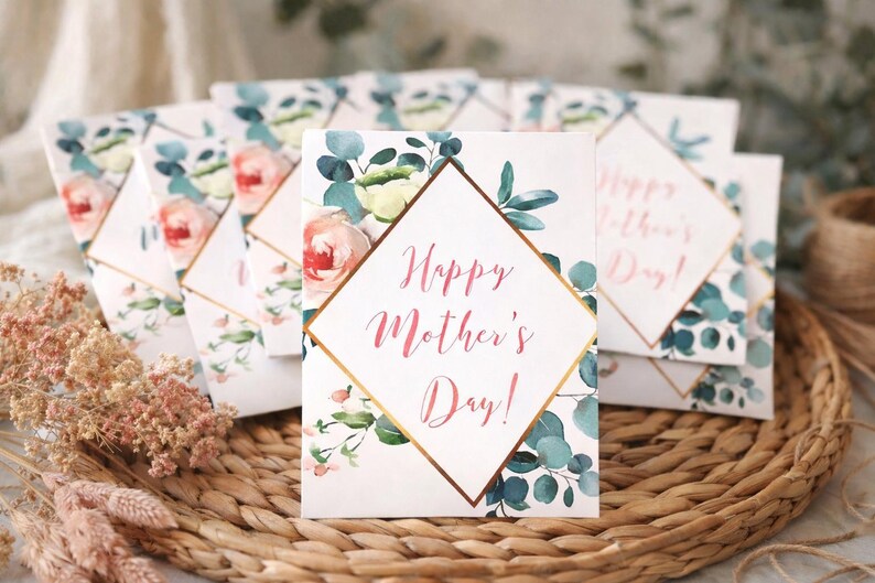 May include: Mother's Day greeting cards with floral designs. Each card features a diamond-shaped frame with the text "Happy Mother's Day!" in pink script. The cards are decorated with watercolor roses and eucalyptus leaves.