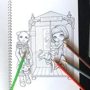 May include: A black and white coloring book page featuring a circus scene with a child in a clown costume holding a mask and another child riding a carousel elephant. The text CIRCUS is visible at the top. Three colored pencils lie across the page.