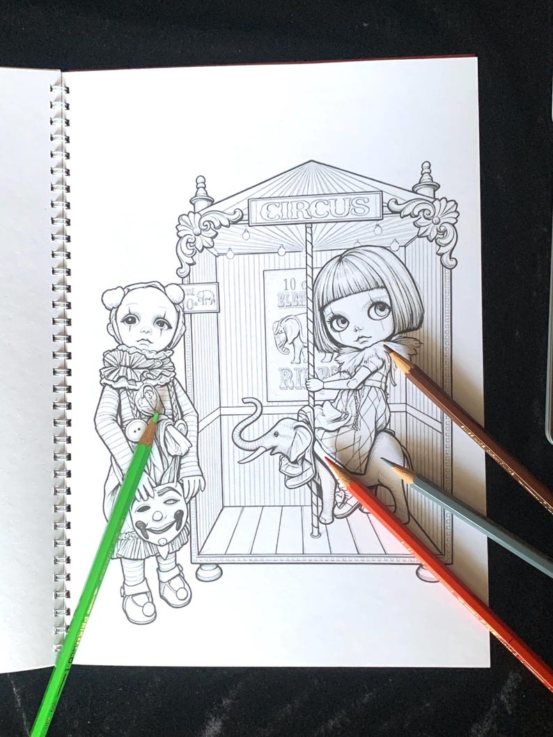 May include: A black and white coloring book page featuring a circus scene with a child in a clown costume holding a mask and another child riding a carousel elephant. The text CIRCUS is visible at the top. Three colored pencils lie across the page.