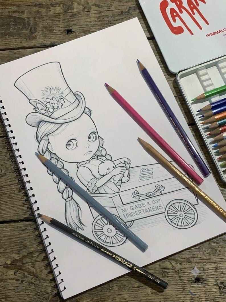 May include: A graphite drawing in a spiral-bound sketchbook depicting a doll with braided hair wearing a top hat, sitting in a wheeled cart labeled M. GABB & COP UNDERTAKERS with RIP on the side. Several colored pencils are placed on the page.