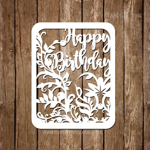 May include: White paper cut-out card with a floral design and the words "Happy Birthday" in a decorative font.