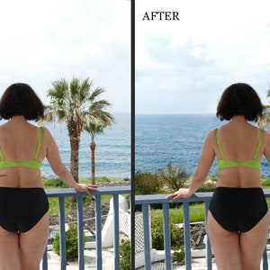 May include: A woman in a green bikini top and black bikini bottoms stands on a balcony overlooking the ocean. She is looking out at the view.