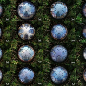 May include: A collection of 16 hand-hammered steel tongue drums, also known as tank drums, arranged in a grid pattern. Each drum has a unique, intricate design and a variety of blue, silver, and brown tones.