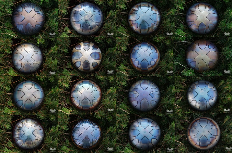May include: A collection of 16 hand-hammered steel tongue drums, also known as tank drums, arranged in a grid pattern. Each drum has a unique, intricate design and a variety of blue, silver, and brown tones.
