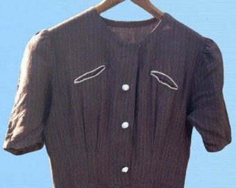 May include: A brown and white striped dress with a button-up front and short sleeves. The dress has white trim around the pockets and collar.