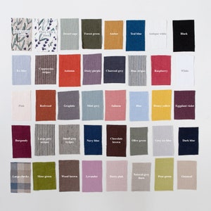 May include: A chart of 40 fabric swatches with names for each color. The swatches are arranged in a grid of 8 columns and 5 rows. The colors include: Flora natural linen, Flora white linen, Desert sage, Forest green, Amber, Teal blue, Antique white, Black, Ice blue, Cappuccino stripes, Autumn, Dusty purple, Charcoal grey, Blue stripes, Raspberry, White, Pink, Redwood, Graphite, Mint grey, Salmon, Blue, Honey yellow, Eggplant violet, Burgundy, Large grey stripes, Small grey stripes, Navy blue, Chocolate brown, Olive green, Grey ice blue, Dark blue, Large checks, Moss green, Wood brown, Levander, Dusty pink, Natural grey linen, Pear green, Oatmeal.