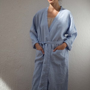 May include: A light blue robe with a sash and pockets. The robe is made of a soft, lightweight fabric.