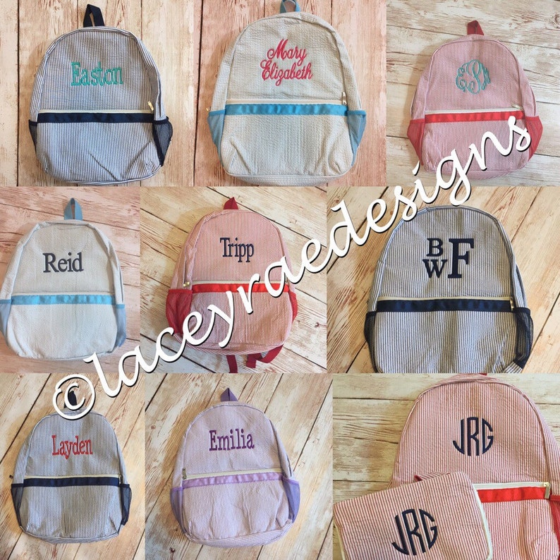 May include: Nine personalized striped canvas backpacks with various colors and embroidered names and initials. The backpacks have a zippered pocket on the front and a mesh pocket on the side.