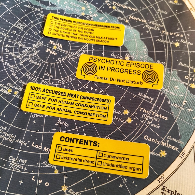 A picture of four different designs of rectangular yellow stickers.