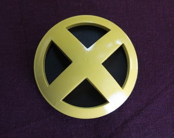 May include: A yellow X-Men logo with a black centre, on a purple background.