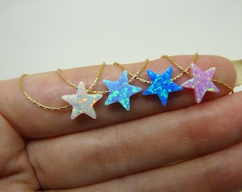 May include: A gold chain necklace with five star-shaped opal pendants. The opals are iridescent and come in shades of white, blue, and pink.