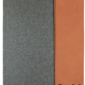 May include: A gray fabric folder with a brown leather flap. The flap has the text "Wayne Craft" printed on it.