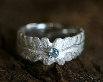 Wonderful silver ring in shape of a fern leaf with a waterblue topas