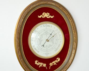 Classic barometer gold on red velvet, Louis XVI style.