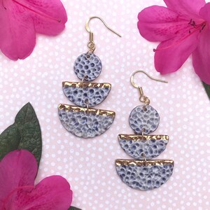 Hammered look statement earrings in plum and gold