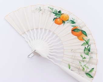 White silk fan inspired by Seville. Bridal fan decorated with a bouquet of oranges, orange blossoms and lilies.