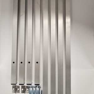May include: Eight silver metal table legs, four silver metal hinges, and eight silver metal screws with a business card that says "Our team has been planted in efforts to help you grow. Thank you!" with a website address.
