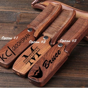 May include: Three wooden pocket combs with personalized engravings. The combs are brown and have a folding design. The engravings include "KC|GROOMSMAN", "MICHAEL", and "Bruce".