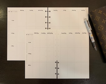 May include: A white weekly planner with a grid for each day of the week. The planner has a black binding with silver rings. The planner is open to the Monday through Sunday pages.
