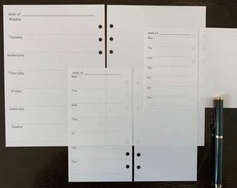 May include: Three white pages with a dotted pattern and holes on the side. The pages are labeled with the days of the week, "Week of", and a blank line for writing the date.