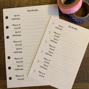 May include: Two white pages with a dotted border and the word "Contacts" at the top. Each page has a list of fields for name, address, phone number, and email.