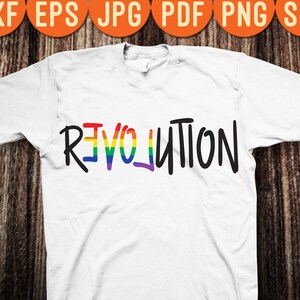 May include: White t-shirt with the word "REVOLUTION" written in black with a rainbow stripe through the "E" and "O".
