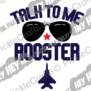 May include: A blue and white graphic design with the text "Talk to me Rooster" in a bold font. The graphic includes a pair of sunglasses with a red star and a silhouette of a fighter jet.