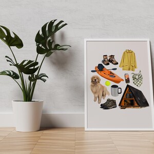 May include: A framed illustration featuring outdoor and camping-themed items. Includes a yellow raincoat, hiking boots, an orange kayak, a golden retriever, a mug, a tennis ball, a cell phone, a bandana, and a small cabin.
