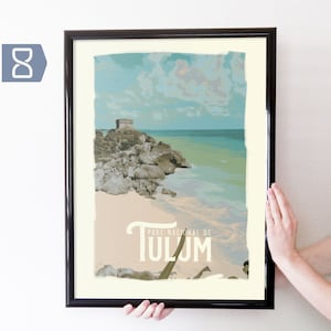 May include: A framed print of a vintage travel poster for Tulum, Mexico. The poster features a colorful illustration of a beach scene with turquoise water, white sand, and a rocky outcropping with a small building. The text "PARC NACIONAL DE TULUM" is printed in a stylized font at the bottom of the poster.