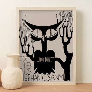 May include: Black and white art print of an owl perched on a tree branch. The owl has large, round eyes and is surrounded by stylized tree branches. The print includes the text "EX LIBRIS STEPHANICSANYI" in black lettering. The artwork is framed in a light wood frame.