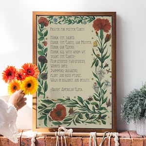 May include: A framed print with a vintage illustration of flowers and insects. The print features a poem about honouring Mother Earth and all living things. The text reads: "Prayer for Mother Earth. Honour the sacred. Honour the Earth, our Mother. Honour our Elders. Honour all with whom we share the Earth - Four-legged, two-legged, winged ones, swimmers, crawlers, plant and rock people. Walk in balance and beauty. - Native American Elder"