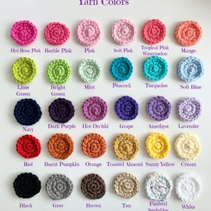May include: A chart of yarn colors with small crocheted circles in each color. The colors are: Hot Rose Pink, Barbie Pink, Pink, Soft Pink, Tropical Pink Watermelon, Mango, Lime Green, Bright Green, Mint, Peacock, Turquoise, Soft Blue, Navy, Dark Purple, Hot Orchid, Grape, Amethyst, Lavender, Red, Burnt Pumpkin, Orange, Toasted Almond, Sunny Yellow, Cream, Black, Grey, Brown, Tan, Funfetti Sprinkles, White.