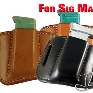 May include: Two leather magazine pouches for Sig Sauer magazines. The pouches are brown and black and have a stitched design. The text "For Sig Mags" is printed in red at the top of the image.